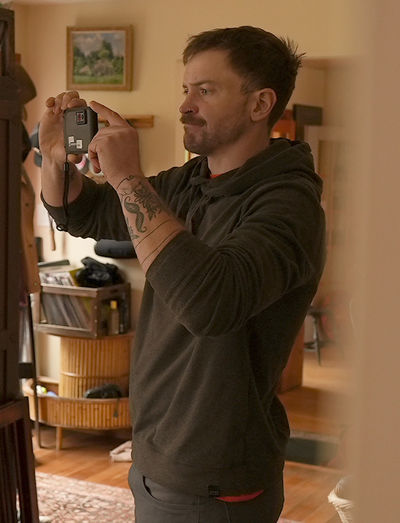Why This Works 02 Man holding up a metering tool while conducting a test in a home
